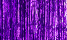 Party Background. Decor Made Of Purple Foil, Tinsel And Candy. Festive And Cheerful Mood