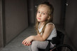 Beautiful sad girl child disabled child sitting in a wheelchair. Victims of a car accident. Disabled children concept