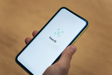 Person uses face id on cell phone.