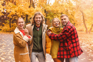 Poster - Happy young friends resting together in autumn park