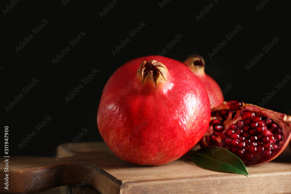 Tasty pomegranate on wooden board
