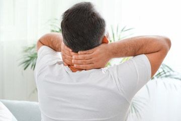 Poster - Mature man suffering from neck pain at home