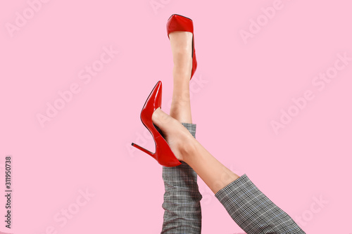 Legs of young woman in high-heeled shoes on color background Poster Mural XXL