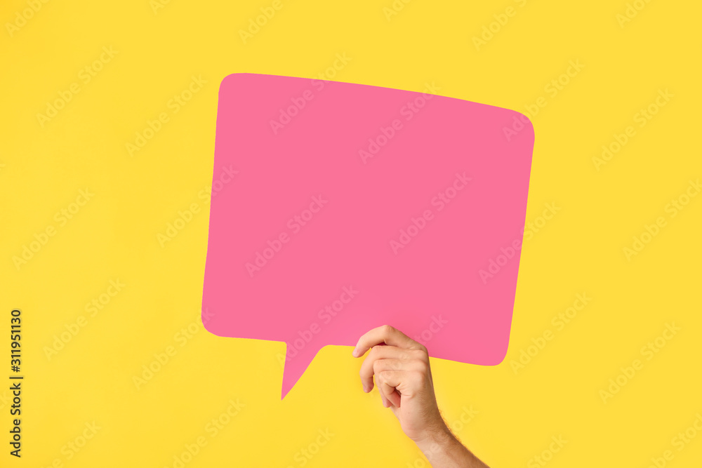 Female hand with blank speech bubble on color background