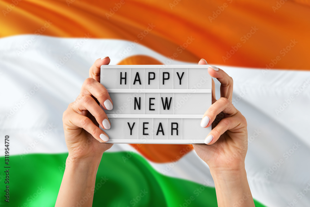 Niger New Year concept. Woman holding Happy New Year sign with hands on ...