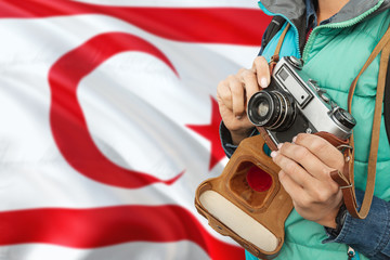 Wall Mural - Northern Cyprus photographer concept. Close-up adult woman holding retro camera on national flag background. Adventure and traveler theme.