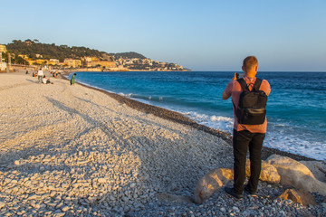 Nice, France, October 9, 2019. The famous Promenade des Anglais embankment and the city beach on the sea.