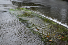 Heavy Rain Caused Flooding Over Sidewalk, Grass Strip, And Road