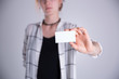 © Fotostudijas.lv - Young woman hand showing blank white bussines card.