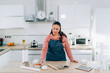 © ManuPadilla - Young Woman preparing Christmas cookies at home. Handmade Ginger Cookies.