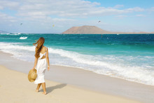 Young Woman Walking On Corralejo Wild Beach Looking At Lobos Island On The Background, Fuerteventura, Canary Islands