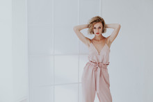 Portrait Of A Beautiful Woman Blonde In A Fashionable Jumpsuit