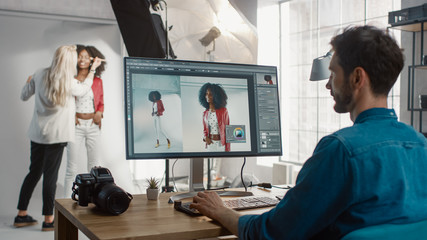 Poster - Backstage of the Photoshoot: Make-up Artist Applies Makeup on Beautiful Black Girl. Photo Editor Works on Desktop Computer Retouching Photo with Image Editing Software. Fashion Magazine