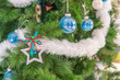 Beautiful Christmas star hanging from a decorated Christmas tree