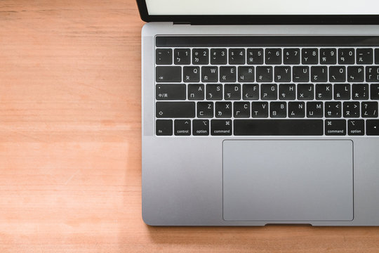 Conceptual workspace, Laptop computer with blank white screen on table, blurred background. use in Traditional Chinese Alphabet operating system.