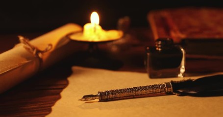 Wall Mural - vintage quill pen and inkwell on old parchment paper in candlelight