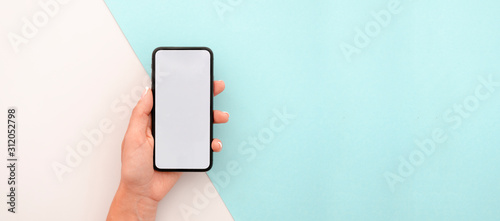 Cuadros en Lienzo Woman hand holding the black smartphone with big blank screen and modern frame less design