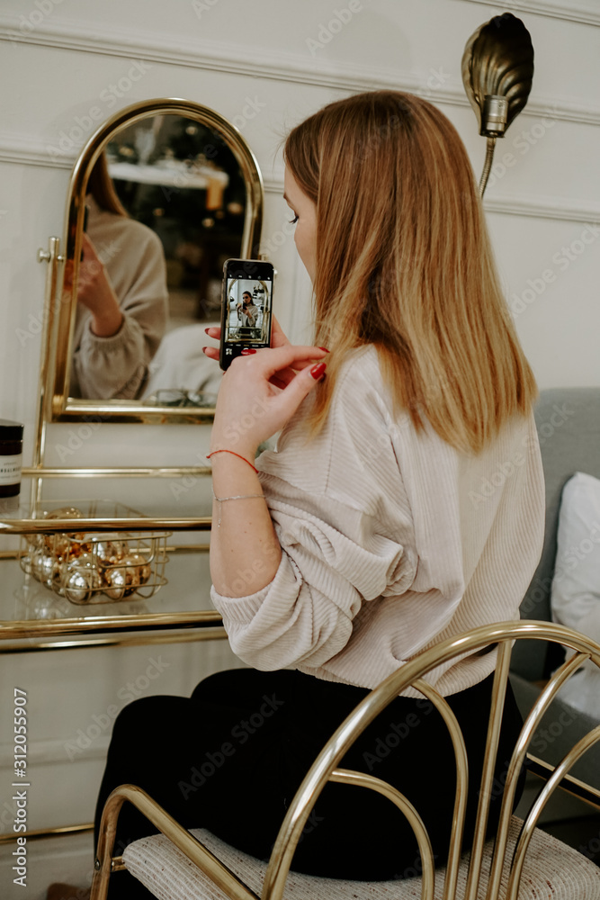 Beautiful woman makes selfie in her room near her dressing table Stock  Photo | Adobe Stock