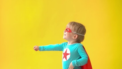 Sticker - Superhero child against yellow background. Slow motion