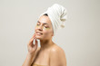© Mountains Hunter - Young beautiful girl in a white towel on his head wears collagen gel patches under her eyes. Mask under eyes treatment face.