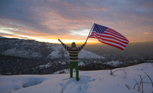 Winter Traveler In The Mountains With USA Flag