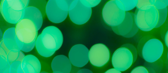 Wall Mural - Abstract Bokeh Blue and green background of defocused glittering lights. Christmas, Party, New Year, luxurious background pattern concept. banner.