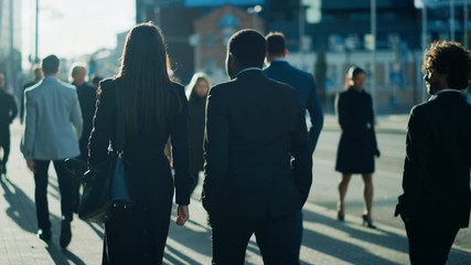 Wall Mural - Office Managers and Business People Commute to Work in the Morning or from Office on a Sunny Day on Foot. Pedestrians are Smart Casually Dressed. Successful People Look Serious and Concentrated.