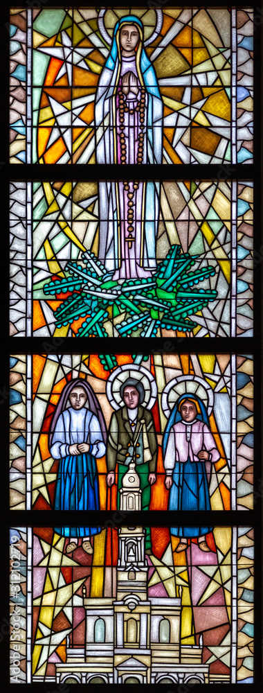 Tylicz, Poland. 2019/8/8. Stained-glass window depicting Our Lady of Fátima with three shepherd children - Lúcia, Jacinta and Francisco. The Sanctuary of Our Lady of Tylicz.
