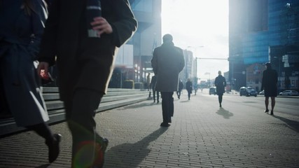 Wall Mural - Office Managers and Business People Commute to Work in the Morning or from Office on a Sunny Day on Foot. Pedestrians are Dressed Smartly. Successful People Walking in Downtown. Cloudy Day in Downtown