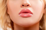 Lips. Beauty injections concept. Close up view of beautiful woman lips with  Peachy lipstick. Fashion make up. Cosmetology, drugstore or fashion makeup. Studio shot. Perfect sexy Lips.  