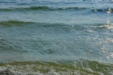 Fototapeta Do pokoju - blue green water background from sea waves and white foam