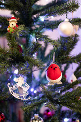 Colorful and sparkling decorations for the Christmas tree. Christmas decorations during the holidays with colored balls and lights. Sample typical photo for family Christmas. Santa Claus night