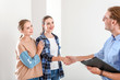 © Pixel-Shot - Woman shaking hands with real estate agent indoors
