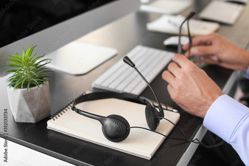 Male technical support agent working in office