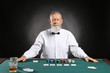 © Pixel-Shot - Mature male banker at table in casino