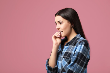 Sticker - Portrait of worried young woman on color background