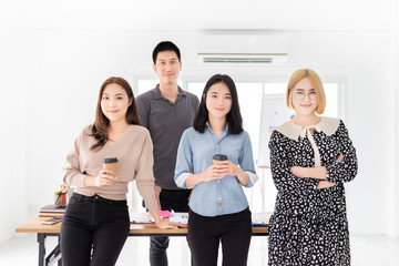 smart asian officer team standing in office, they feeling happy and smile, happiness organization, teamwork and unity