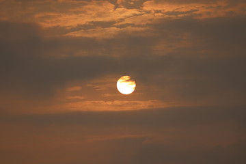 Wall Mural - MORNING SUN SHINING BEHIND THE CLOUDS