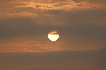 Wall Mural - MORNING SUN SHINING BEHIND THE CLOUDS