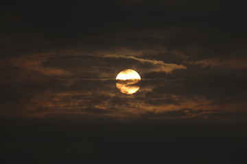 Wall Mural - MORNING SUN SHINING BEHIND THE CLOUDS