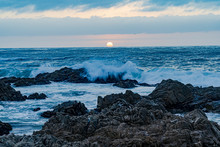 The Surf Pounding On The Rocks At Sunset