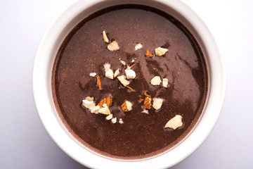 Canvas Print - Sweet Ragi Malt / Healthy Ragi Porridge in a bowl garnished with crushed dry fruits