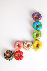 Wall Mural - colorful doughnuts white background studio