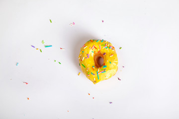 Wall Mural - colorful doughnut sprinkles white background studio