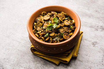 Wall Mural - Tendli / Kundroo sabzi or Kovakkai Poriyal also known as ivy gourd, served in a bowl or karahi. selective focus