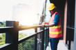 © khwanchai - construction worker measure the length of the balcony at work