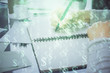 © peshkova - Hand taking notes in notepad. Forex chart holograms in front. Concept of research. Double exposure