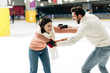 © LIGHTFIELD STUDIOS - beautiful young couple having fun on skating rink
