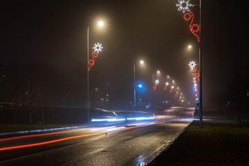 City landscape at foggy night. Long exposure. Light trails.