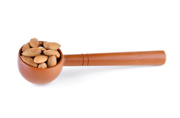 Almonds in wooden spoon isolated over white background